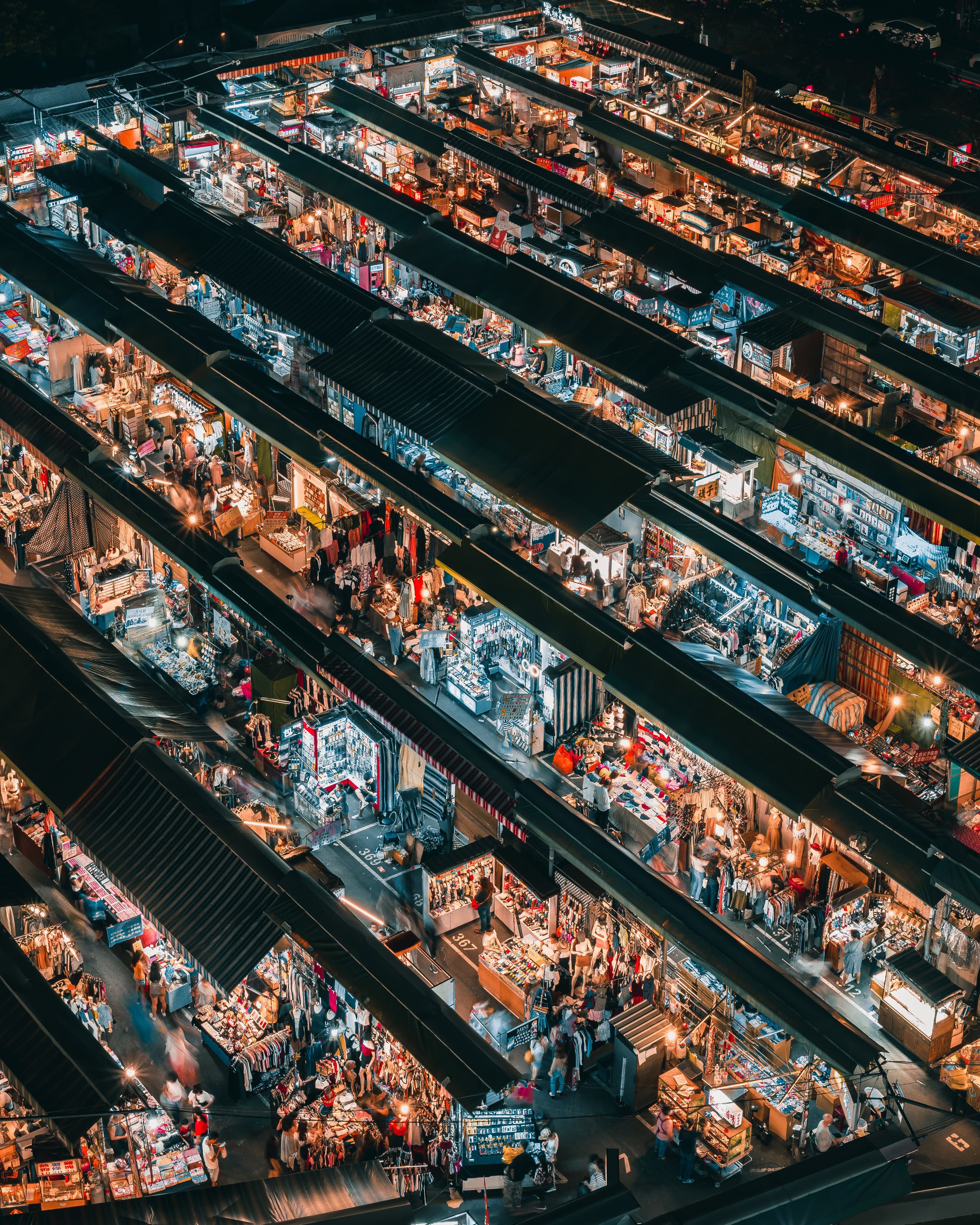 Aerial night view of a busy market — Photo by Allan So from Pexels